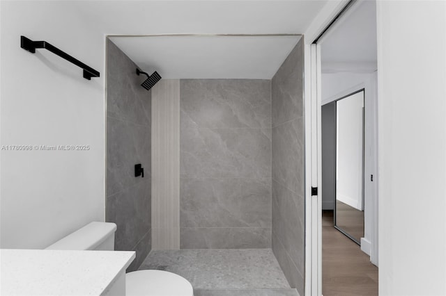 1301 NE 191st St Unit F117, Miami, FL 33179 - bathroom featuring toilet, a shower stall, wood finished floors, and vanity