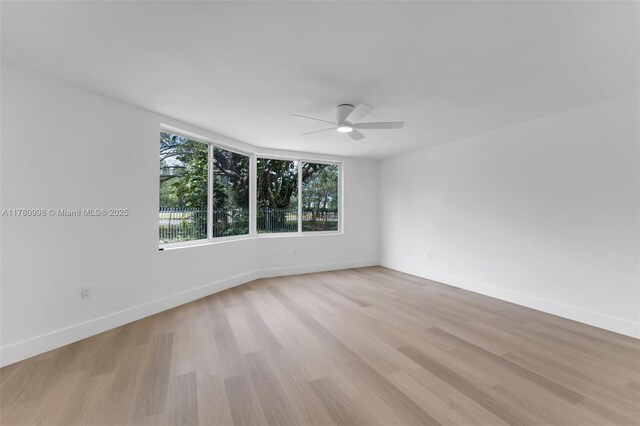 1301 NE 191st St Unit F117, Miami, FL 33179 - spare room featuring baseboards, a ceiling fan, and light wood-style floors