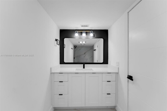 1301 NE 191st St Unit F117, Miami, FL 33179 - bathroom with visible vents, vanity, a marble finish shower, and baseboards
