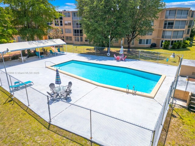 1301 NE 191st St Unit F117, Miami, FL 33179 - community pool featuring a patio, a yard, and fence