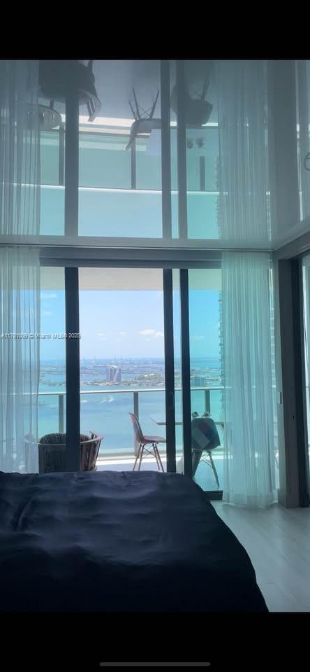 bedroom featuring floor to ceiling windows