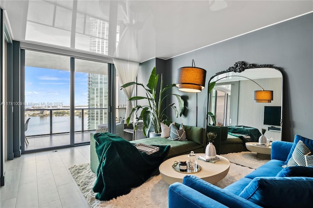 bedroom featuring a water view, tile patterned floors, access to exterior, and expansive windows