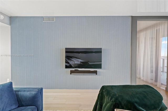 bedroom featuring baseboards and wood finished floors