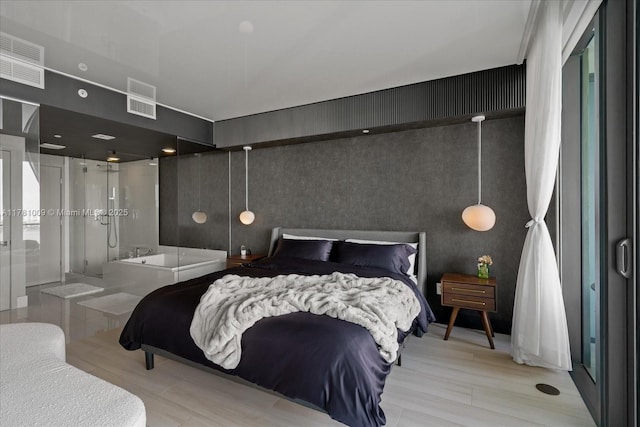 bedroom featuring wood finished floors and visible vents