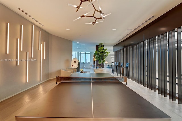 game room featuring baseboards and wood finished floors