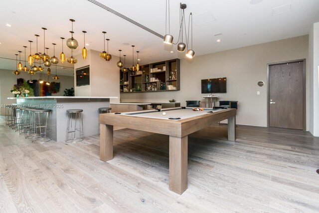 playroom featuring light wood-style floors, pool table, and a dry bar