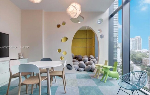 interior space featuring a view of city, arched walkways, and floor to ceiling windows