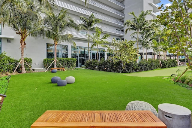 view of home's community with a yard