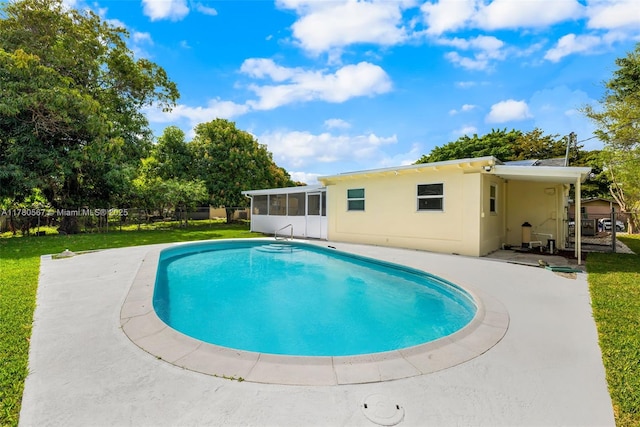 view of swimming pool with a fenced in pool, a patio, a sunroom, fence, and a lawn