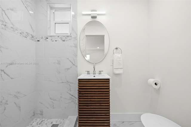 bathroom with baseboards, a tile shower, toilet, vanity, and marble finish floor