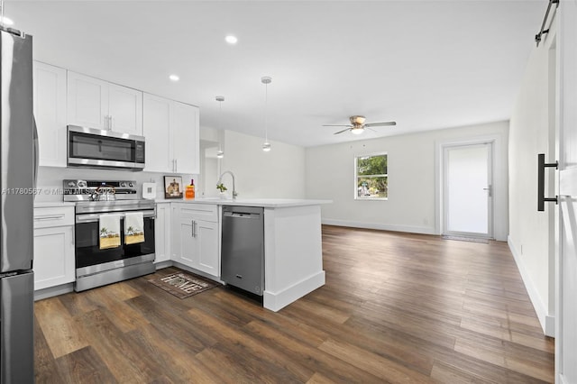 kitchen featuring a peninsula, light countertops, white cabinets, ceiling fan, and appliances with stainless steel finishes