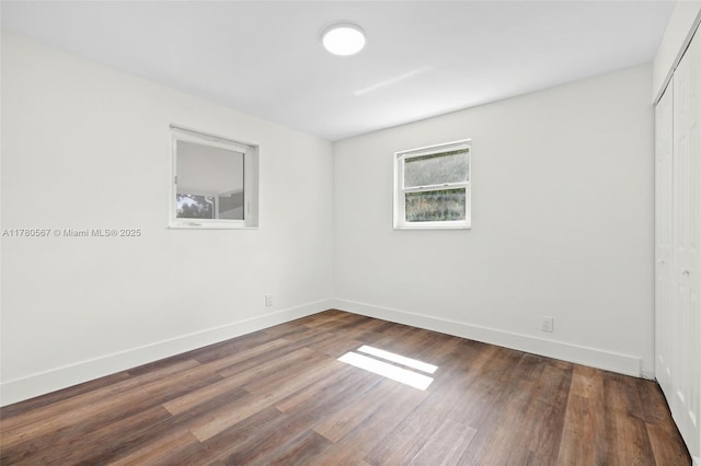 unfurnished room featuring wood finished floors and baseboards