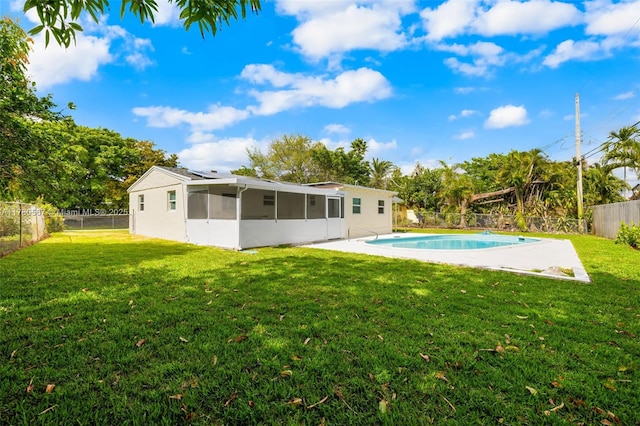 view of pool with a sunroom, a yard, a fenced backyard, and a fenced in pool