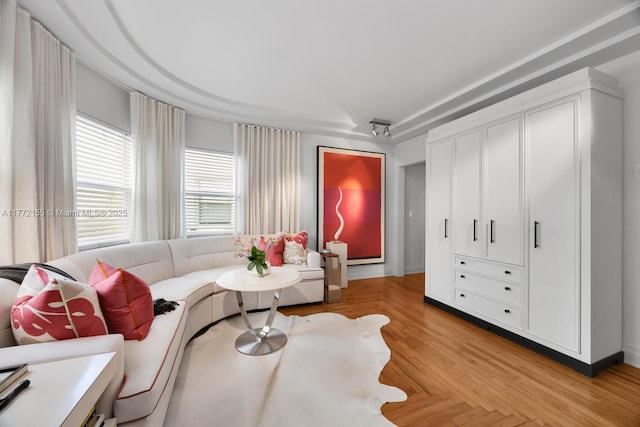 living area featuring baseboards
