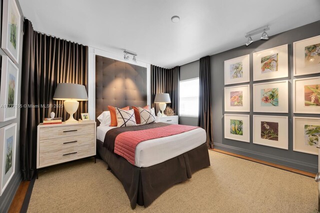 bedroom featuring rail lighting
