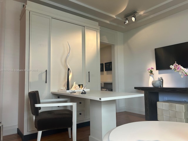 interior space featuring a peninsula, light countertops, and dark wood finished floors