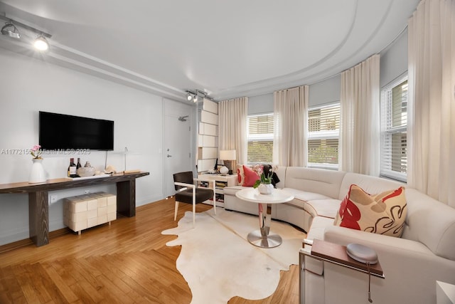 living area with wood finished floors and baseboards