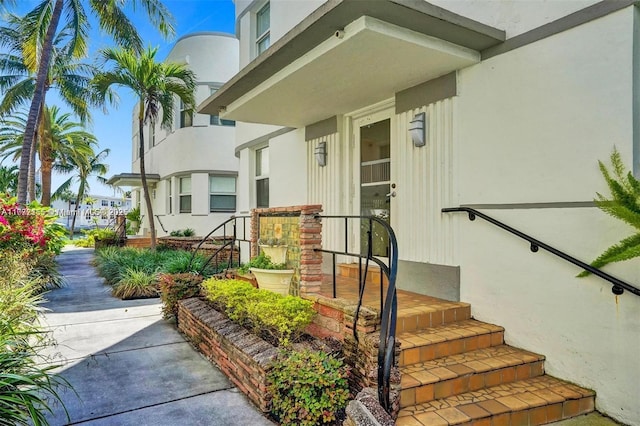 property entrance with stucco siding