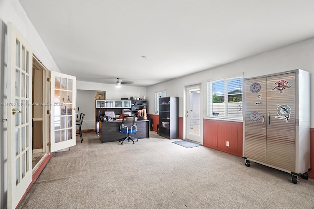 carpeted office with french doors and ceiling fan