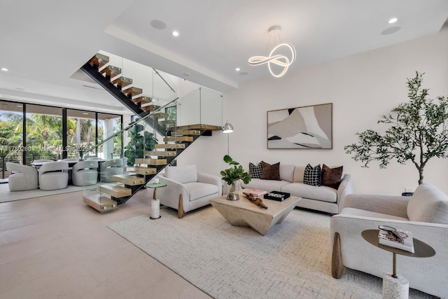 living area featuring stairs, recessed lighting, and floor to ceiling windows