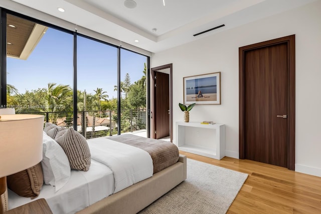 bedroom featuring access to outside, baseboards, recessed lighting, and light wood finished floors