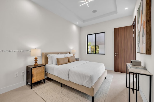bedroom with baseboards, light carpet, recessed lighting, and a raised ceiling