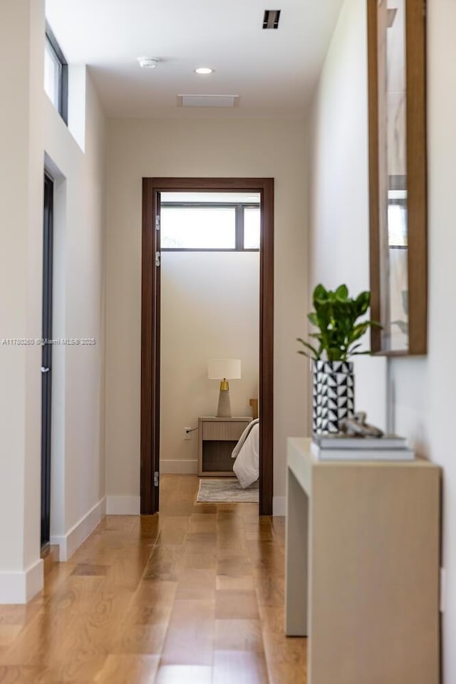 hall with baseboards and a wealth of natural light