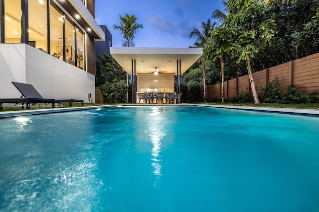 view of pool with a fenced in pool, a fenced backyard, and outdoor dry bar