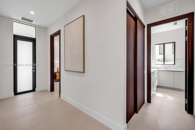 hallway featuring baseboards, recessed lighting, and visible vents