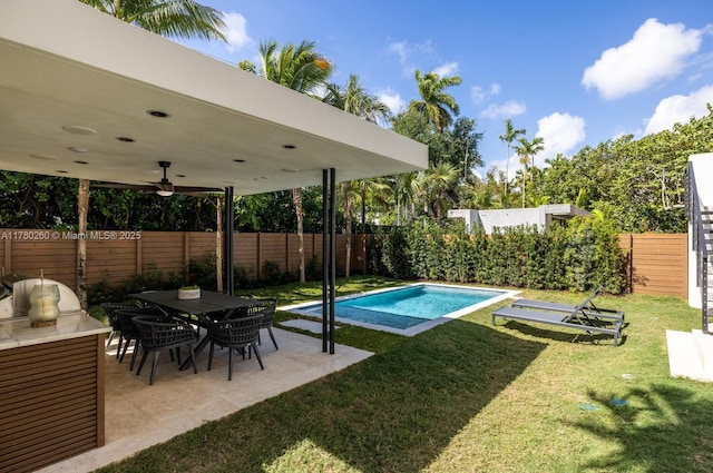 view of pool featuring ceiling fan, a fenced backyard, a fenced in pool, a patio area, and a yard