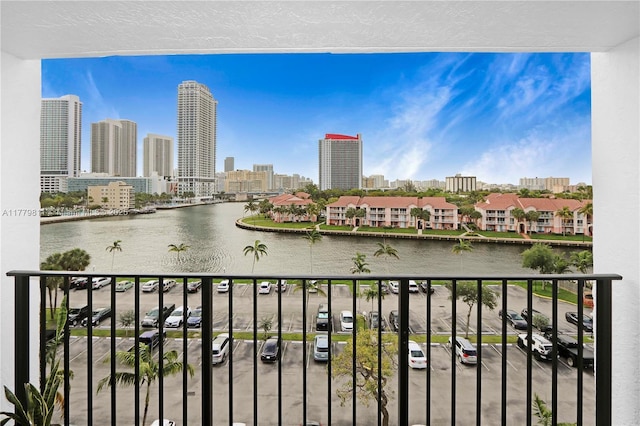 balcony featuring a city view and a water view