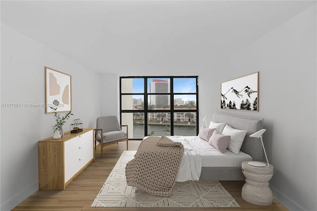 bedroom featuring light wood-type flooring and baseboards