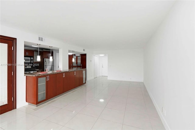 kitchen with hanging light fixtures, baseboards, visible vents, light tile patterned floors, and appliances with stainless steel finishes