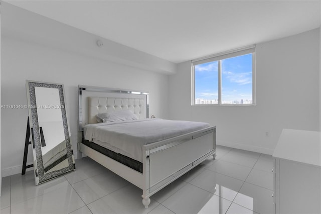 bedroom featuring baseboards and light tile patterned flooring