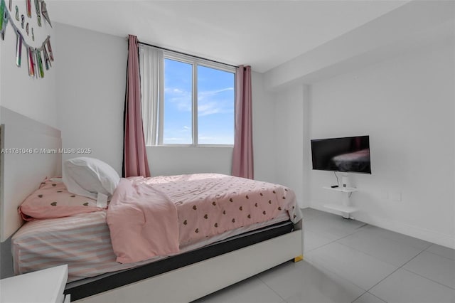 bedroom with tile patterned flooring and baseboards