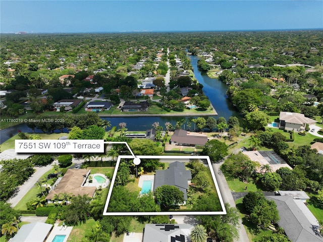 7551 SW 109th Ter, Pinecrest, FL 33156 - aerial perspective of suburban area with property parcel outlined and a large body of water