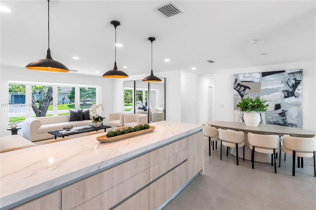 7551 SW 109th Ter, Pinecrest, FL 33156 - kitchen with light brown cabinetry, modern cabinets, light stone countertops, finished concrete flooring, and recessed lighting