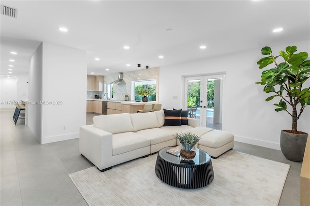 7551 SW 109th Ter, Pinecrest, FL 33156 - living area with recessed lighting, french doors, and finished concrete flooring