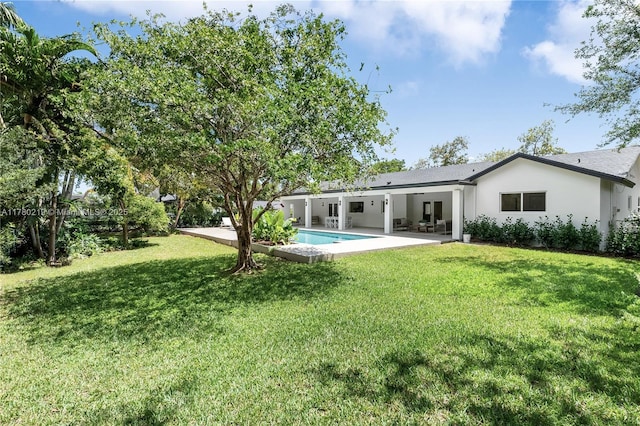 7551 SW 109th Ter, Pinecrest, FL 33156 - rear view of house featuring a patio, a lawn, stucco siding, and an outdoor pool