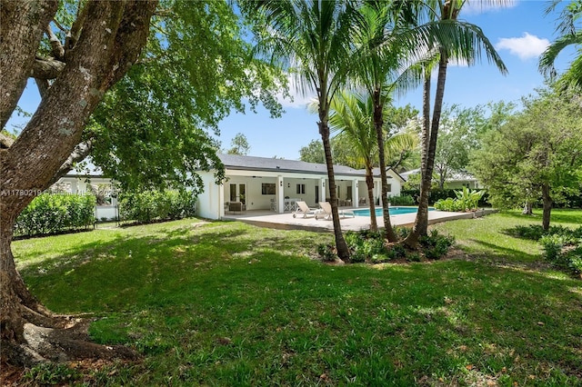 7551 SW 109th Ter, Pinecrest, FL 33156 - back of property with a patio area, a yard, an outdoor pool, and french doors