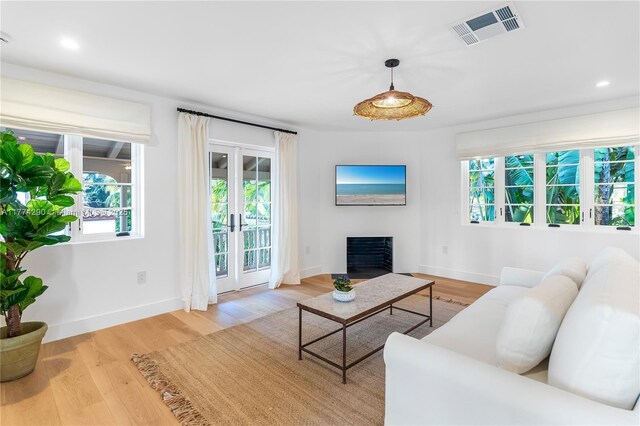 1225 N Greenway Dr, Coral Gables, FL 33134 - living room featuring healthy amount of natural light, wood finished floors, a fireplace, and recessed lighting