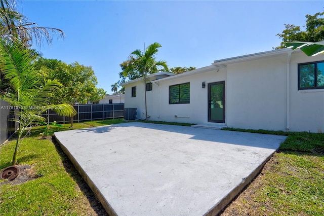back of house with a fenced backyard, stucco siding, cooling unit, and a patio area