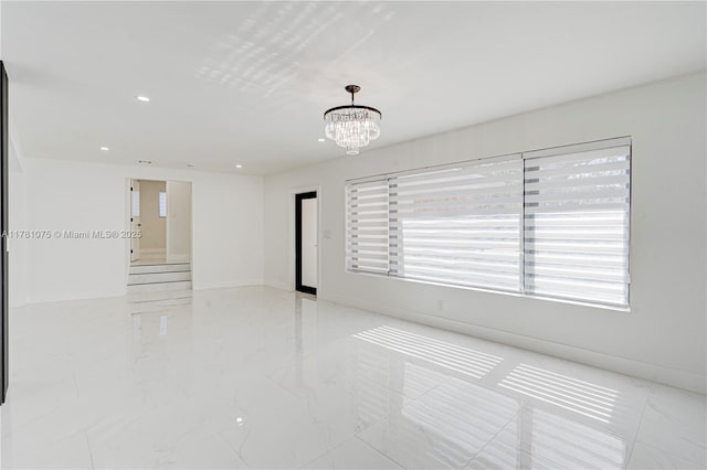 spare room with a chandelier, recessed lighting, baseboards, and marble finish floor
