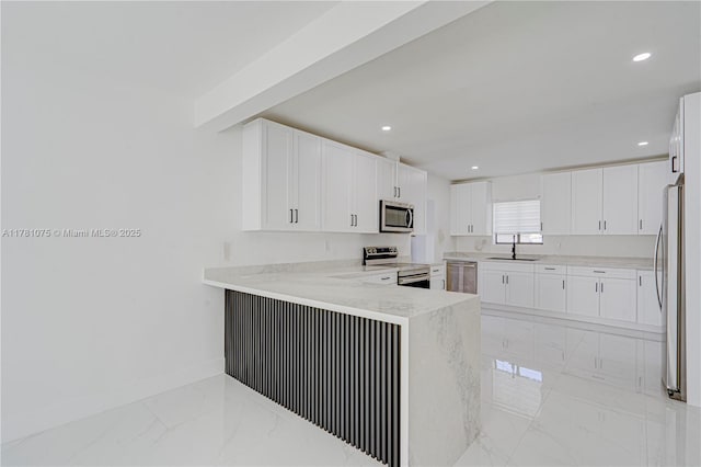 kitchen with white cabinets, a sink, stainless steel appliances, baseboards, and marble finish floor