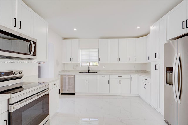 kitchen with appliances with stainless steel finishes, recessed lighting, marble finish floor, and a sink