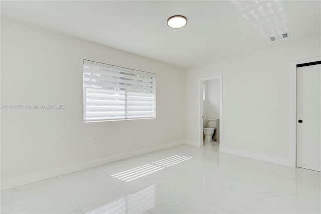 unfurnished bedroom featuring marble finish floor, visible vents, connected bathroom, and baseboards