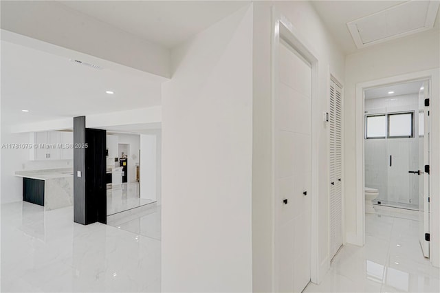 hallway with recessed lighting, marble finish floor, and visible vents