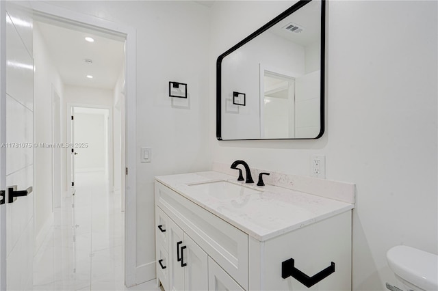 bathroom featuring recessed lighting, toilet, vanity, baseboards, and visible vents