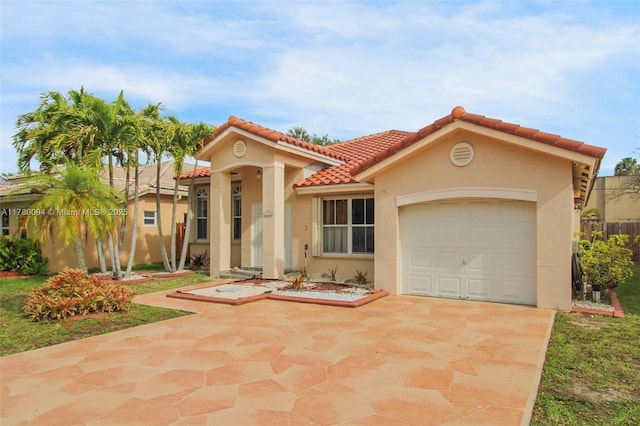 mediterranean / spanish-style house featuring a garage, stucco siding, driveway, and a tile roof