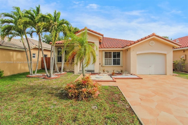 mediterranean / spanish house featuring stucco siding, a front lawn, a tile roof, an attached garage, and driveway